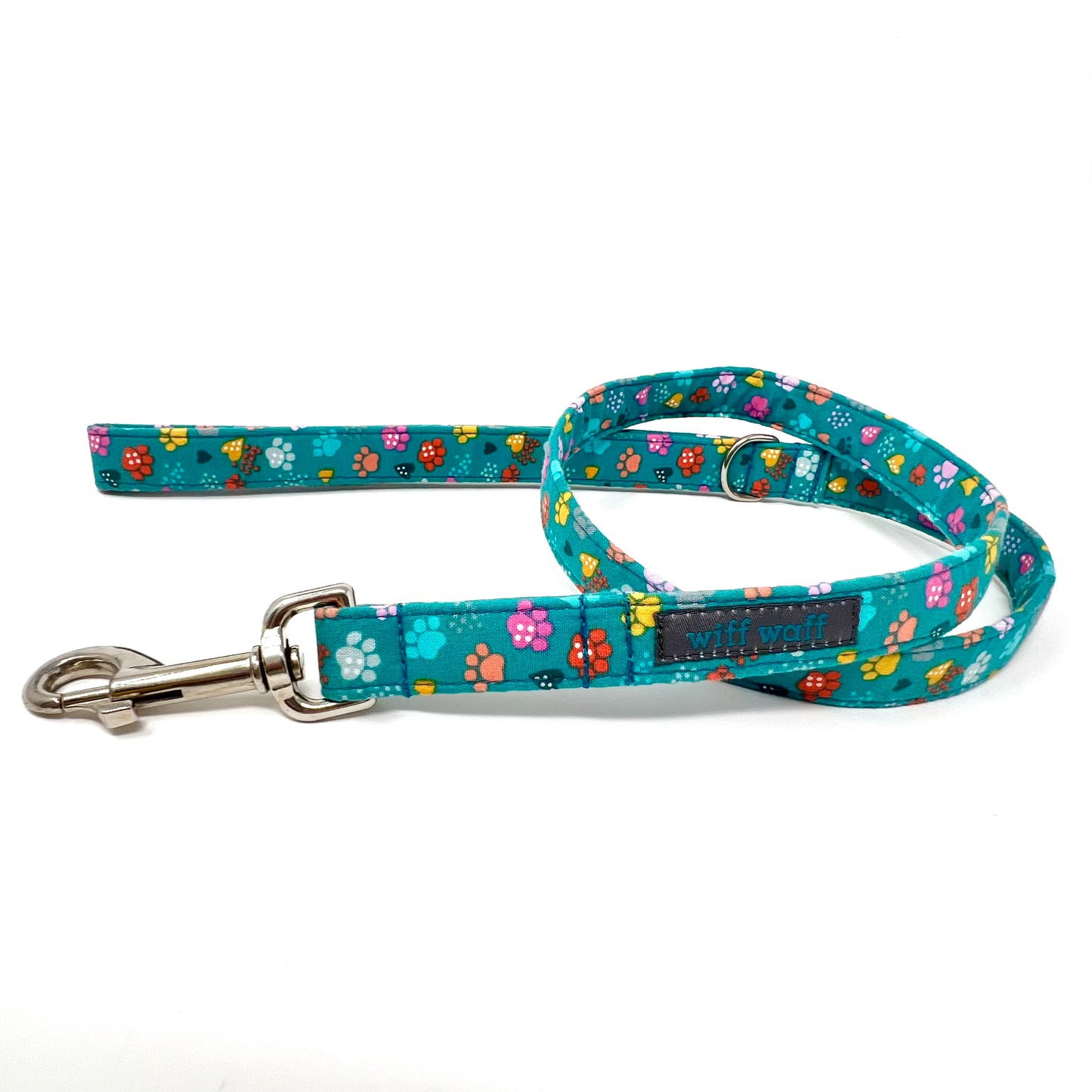 Dog leash with colourful paw patterns on a turquoise background
