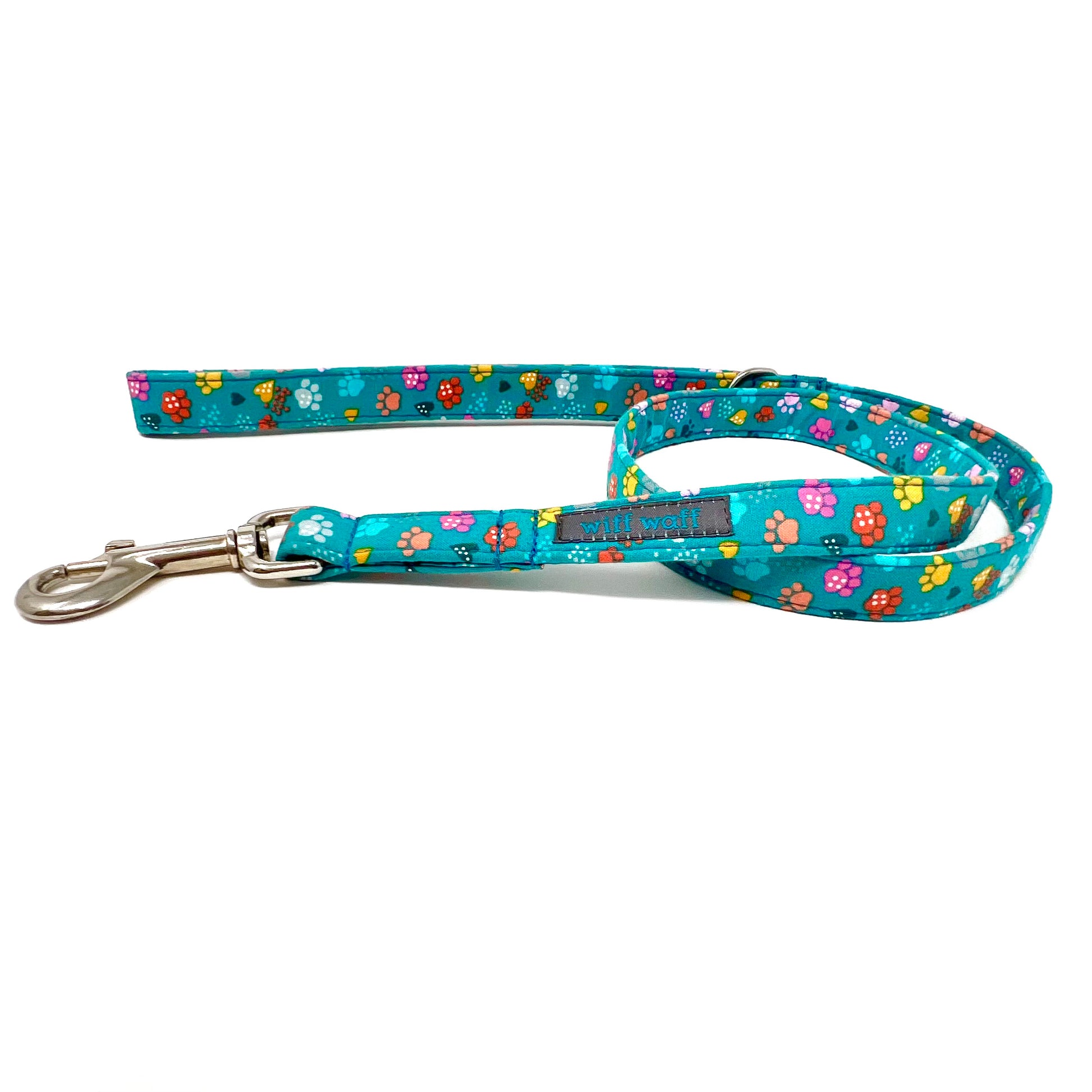 Dog lead with colourful paw patterns on a turquoise background