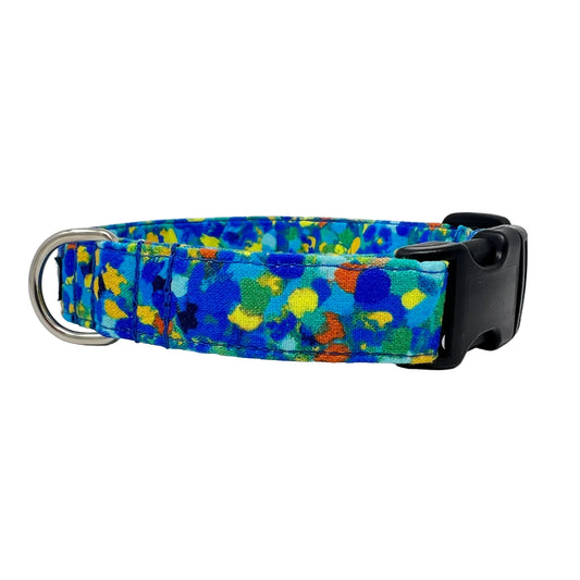 Dog collar with splattered dots of blues and a touch of yellow, green and orange.
