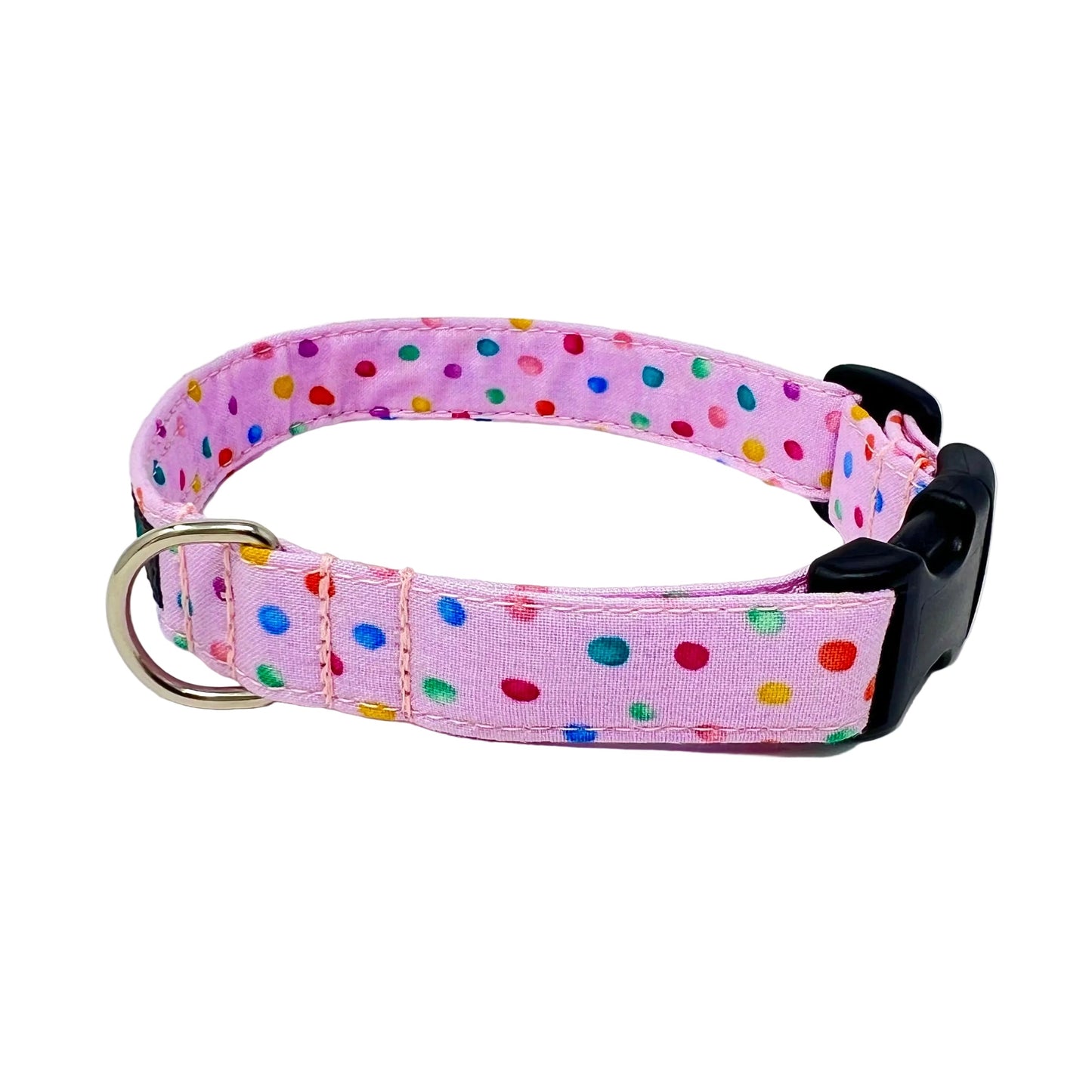 dog collar with a pink back ground with tiny colourful rainbow bubbles scattered across it
