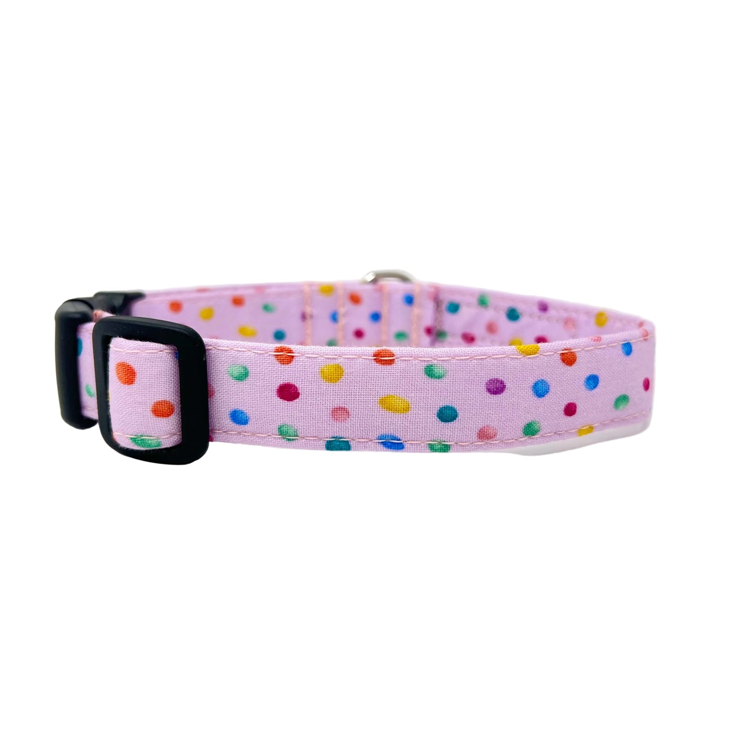 dog collar with a pink back ground with tiny colourful rainbow bubbles scattered across it