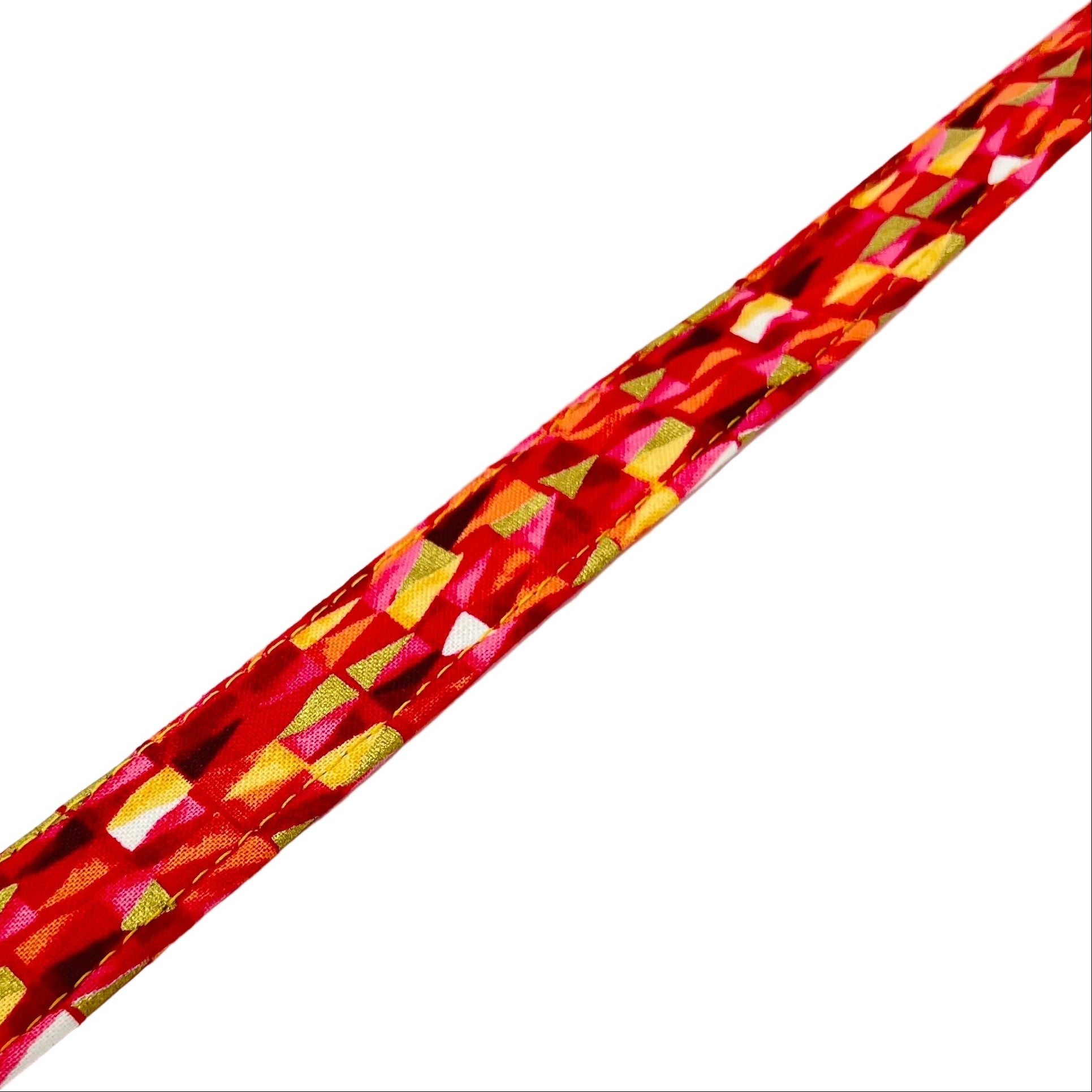 Fabric reinforced dog collar with a triangular pattern in shades of pinks and reds with gold metallic highlights