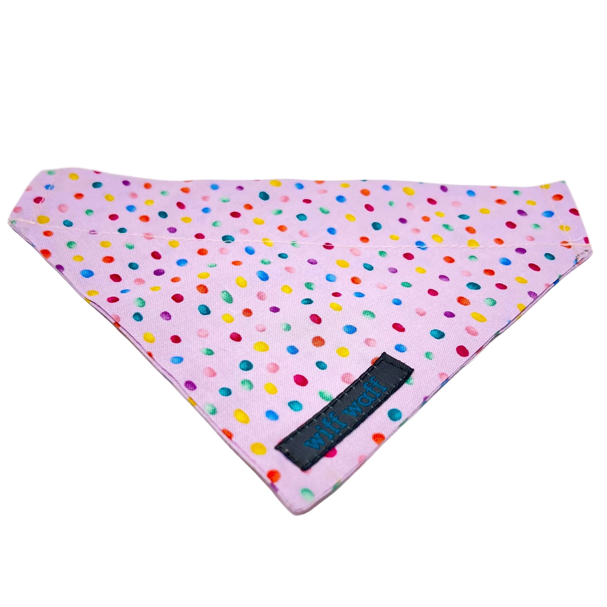 a dog bandana which has a pink back ground with tiny colourful rainbow bubbles scattered across it.
