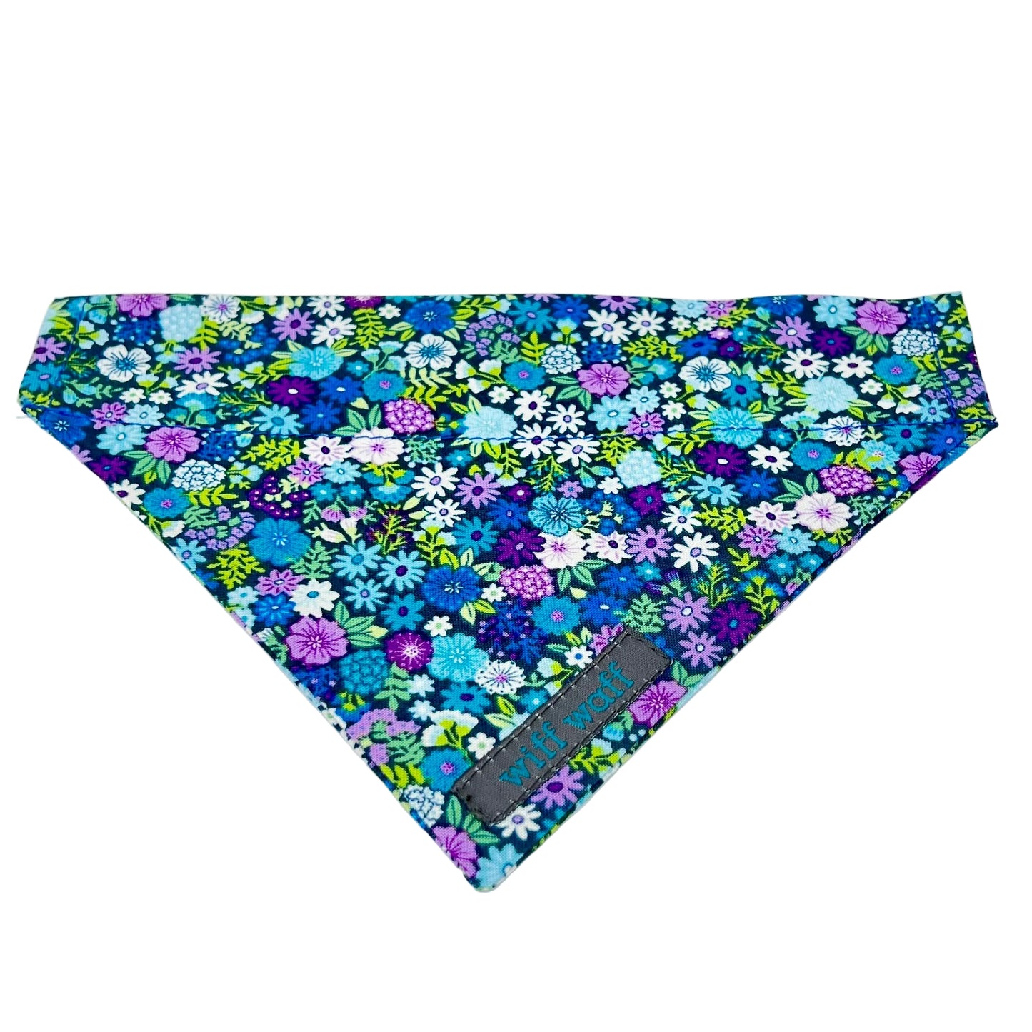 a dog collar bandana features a vibrant floral design in shades of blue, violet, green and white, giving it a refreshing look.