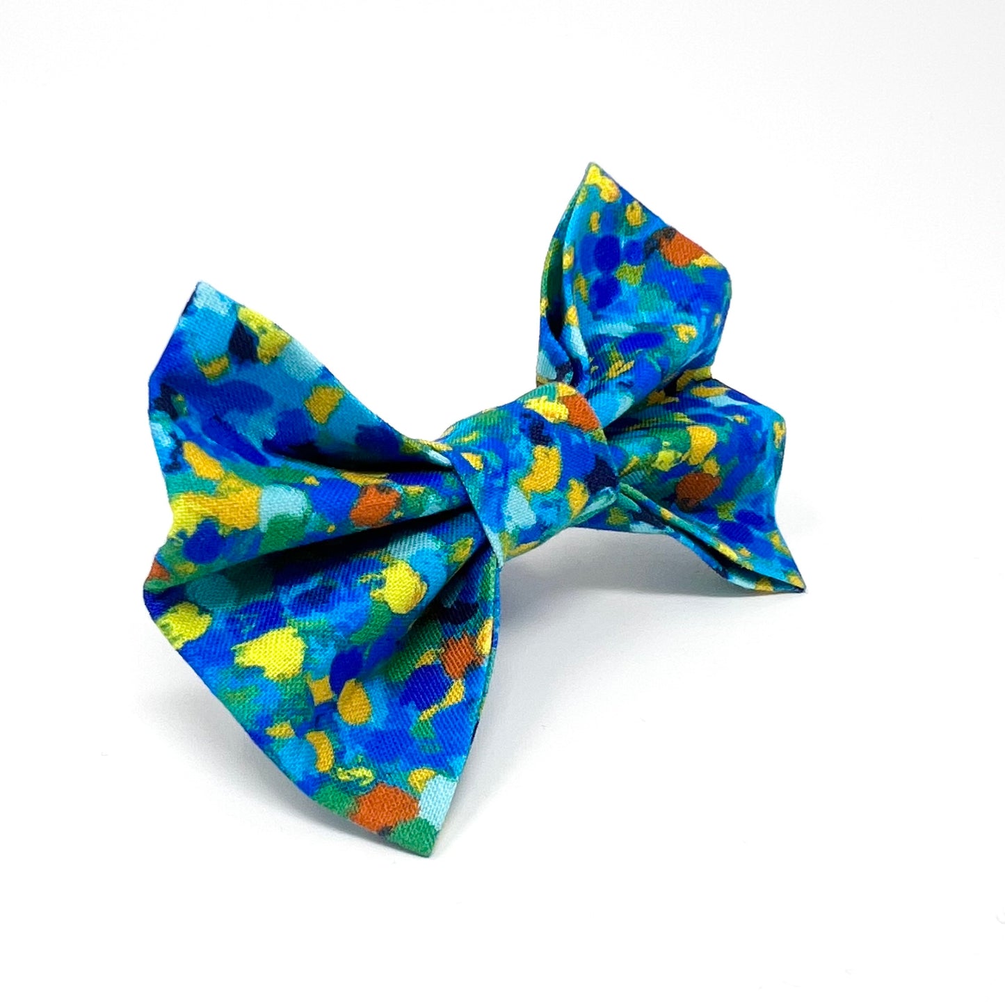 Bow tie composed of various blue tones, complemented by subtle accents of yellow, orange, and green.