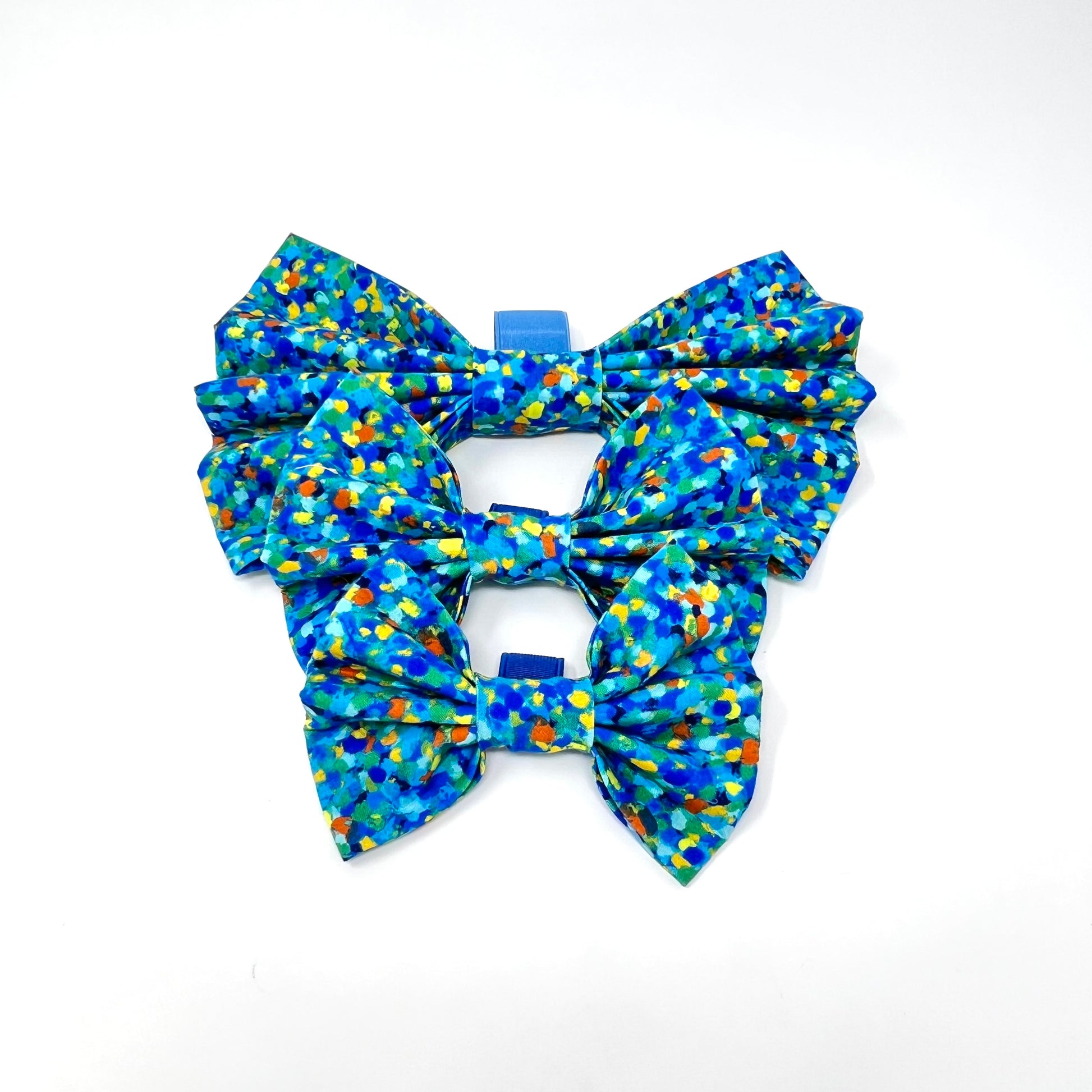 large plus, small Xl and XL bow tie composed of various blue tones, complemented by subtle accents of yellow, orange, and green.