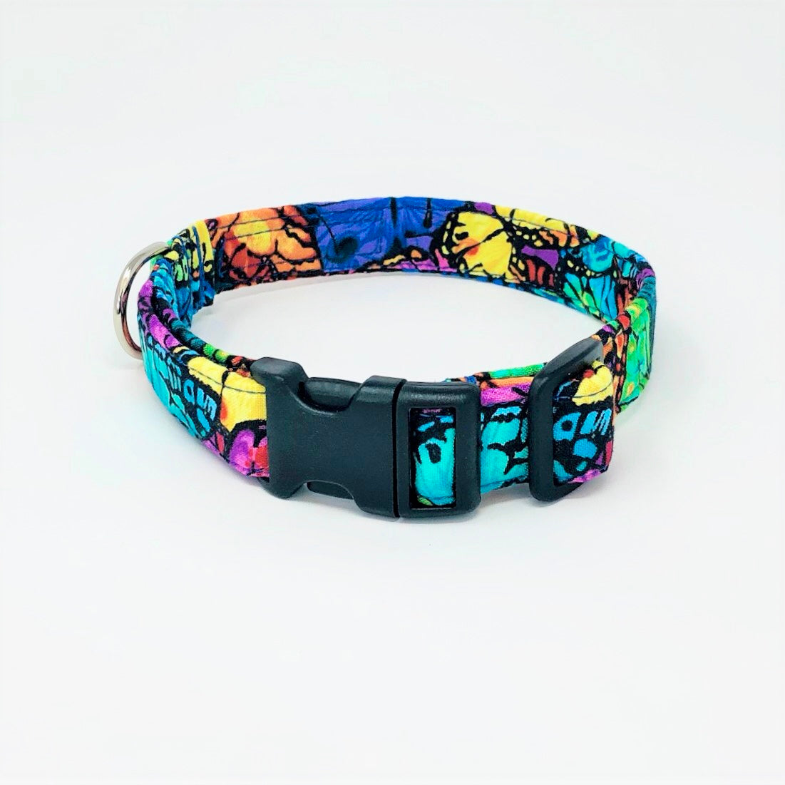 Handcrafted dog collar by wiff waff designs in a vibrant colourful butterfly print with shades of blue, orange, yellow, turquoise, pink, red and purple. Black triglide and clip plus shiny chrome d ring.