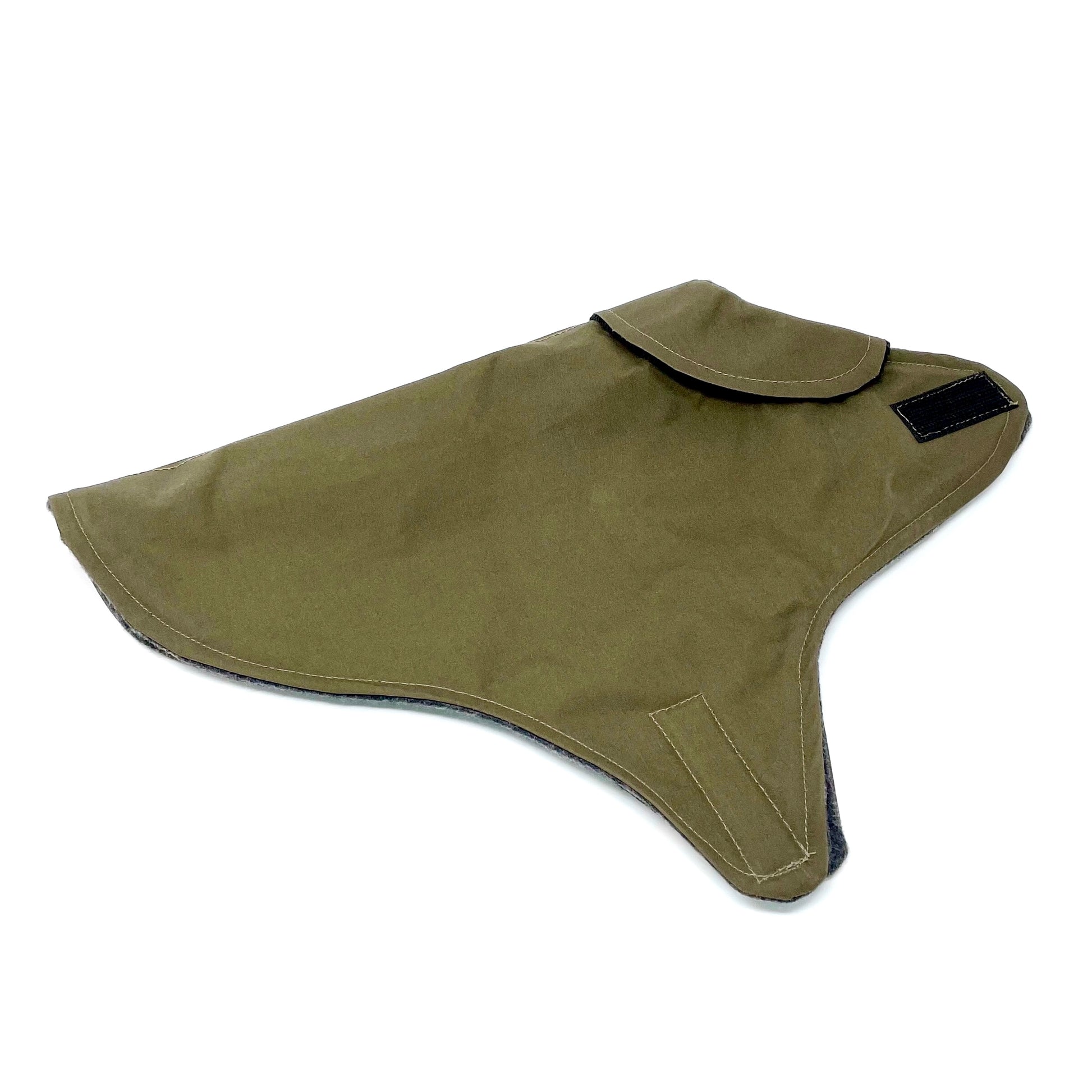 Khaki wax cotton dog coat with collar, folded in half and laid flat on a white background.