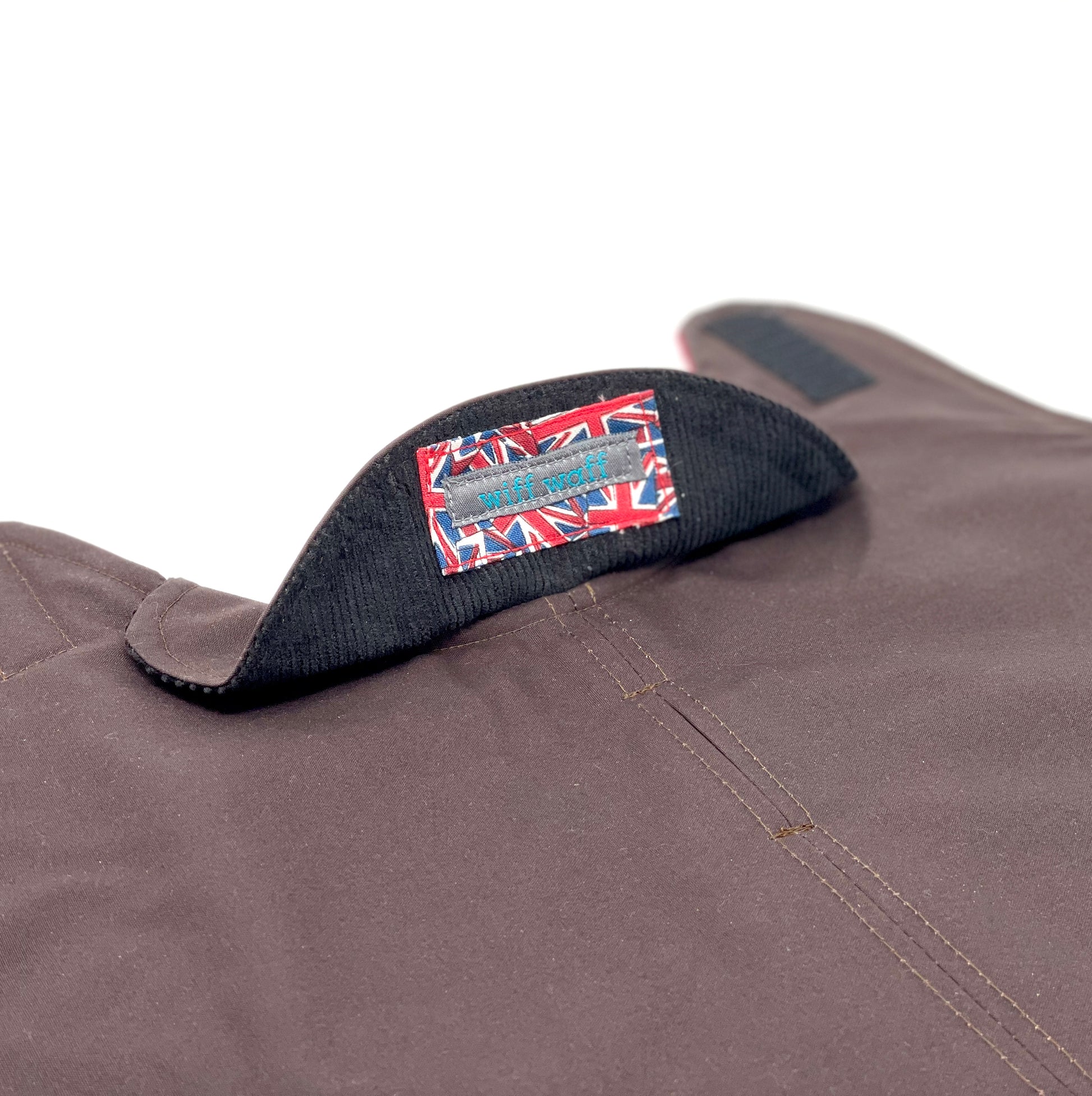 Chocolate brown dog coat collar which is folded up to show soft brown corduroy fabric with Wiff Waff logo stitched on to a piece of Union Jack fabric.